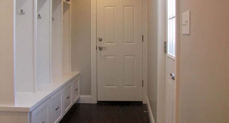 white cabinets and door in a hallway