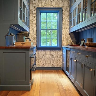 blue kitchen cabinets and window
